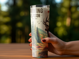 Tumbler with "Hunting Season" text and deer graphic, held by a hand.