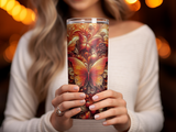 Woman holding a tumbler with an intricate butterfly and floral pattern.