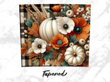 Fall floral arrangement with pumpkins, poppies, and wheat on plaid.