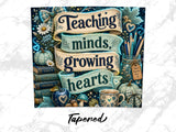 "Teaching minds, growing hearts" banner with books, pencils, and pumpkin decoration.