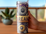 Tall tumbler with sunflower and star designs, reads "DREAM".