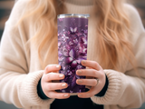 Purple tumbler with butterfly and floral design, held by hands.