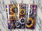Sunflower tumbler with "DREAM" text on a marble background.