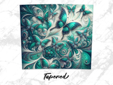 Teal butterflies with intricate patterns on a swirling, sparkly background.