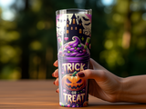 Purple tumbler with Halloween design of haunted house, bats, pumpkin, and "trick or treat" text.