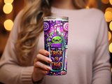 Spooky Halloween tumbler with candy, straw, and cartoon monster.