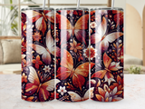 Three tumblers with a dark background featuring intricate, colorful butterfly and floral designs.