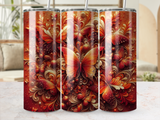Golden and red butterflies with intricate swirling patterns on a tumbler.