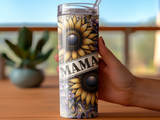 Sunflower pattern tumbler with "MAMA" text held by hand.