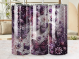 Three tumblers with purple butterflies and floral patterns.