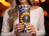 Woman holding a floral sunflower tumbler with decorative purple flowers.