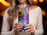 Woman holds a tall tumbler with a colorful witch cat design.