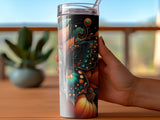 Hand holding a tall tumbler with a detailed floral and pumpkin design.