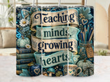 Teacher-themed tumbler with "Teaching minds, growing hearts" and decorative elements.