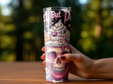 Tumbler with a skull topped with colorful frosting and candy.
