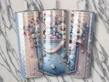 Denim pocket tumbler with floral and pearl embellishments on marbled background.