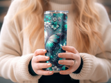 Tumbler with teal and white floral and butterfly pattern.