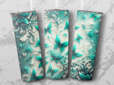 Three tumblers with teal butterflies and ornate floral patterns.