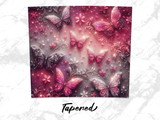 Pink and purple butterflies and flowers with glitter on textured background, "Tapened" text.