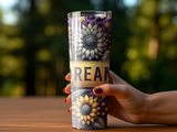 Hand holding tall tumbler with sunflower and star pattern, featuring "DREAM" text.