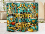 Tumbler with "I teach therefore I drink coffee" text, books, apple, and coffee cups.