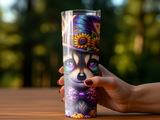 Tumbler with a cartoon raccoon wearing a witch hat and bow tie, surrounded by pumpkins.