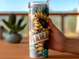 Tall tumbler with sunflowers and the word "MAMA" in gold glitter.