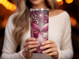 Woman holding a tumbler with a pink butterfly design.