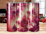 Three tumblers with pink butterfly and floral designs on a wooden surface.
