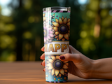 Woman's hand holding a tumbler with sunflowers and the word "HAPPY".