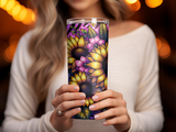Woman holds floral tumbler with sunflowers and purple accents.
