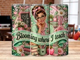 Teacher with glasses and pink accents surrounded by books and flowers.
