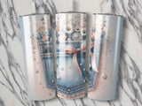 Three tumblers with denim pocket, pearl, and floral designs.