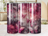 Tumbler with pink and purple butterflies and floral designs.