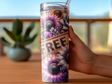 Woman holding a tumbler with sunflowers and the word "FREE" in large glittery letters.