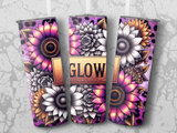 Three tumblers with floral designs and the word "GLOW" on a gray background.