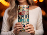 Tumbler with "The American Spirit Lives On" text and patriotic graphics.