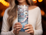Woman holding a decorative glass tumbler with denim, pearls, and floral accents.
