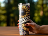 Sunflower-adorned tumbler with "Mama" text held by a hand.