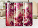 Pink and gold butterflies and floral patterns on a cylindrical tumbler.
