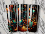 Three tumblers with intricate floral and pumpkin autumn designs.