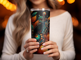 Woman holding a tall tumbler with a colorful butterfly and floral design.