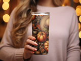 Tumbler with autumn harvest design: pumpkins, cinnamon sticks, coffee cup, pinecones.