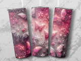 Three tumblers with pink glittery butterfly and floral designs.