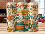 Tumbler with "You Were More Than a Teacher" text, books, and school supplies.