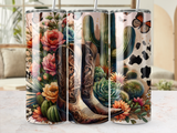 Cowboy boots surrounded by desert flowers, succulents, and butterflies.