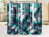 Three tumblers with iridescent butterfly and floral designs against a dark, sparkling background.