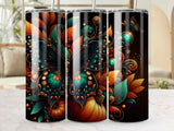 Three tumblers with a black background featuring pumpkins, leaves, and a butterfly.