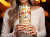 Woman holds a tumbler with "Sunshine and happiness" text and decorative hearts.