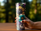 Tumbler with sunflowers and colorful floral design held by a hand.
